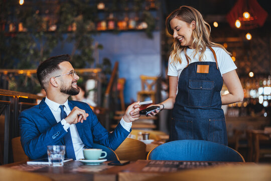 Friendly Interaction Between Businessman and Waitress in Cafe