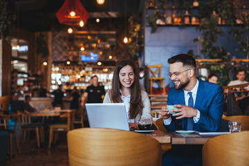 Professional Meeting in Modern Café Setting with Smiling Colleagues