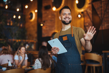 Smiling Waiter Greeting Customers in a Cozy Restaurant Setting