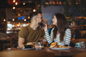 Happy Couple Enjoying Breakfast Together in Cozy Cafe