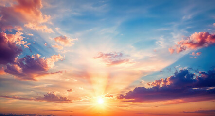 Fototapeta premium Sun shining through colorful clouds on a summer evening. High quality photo