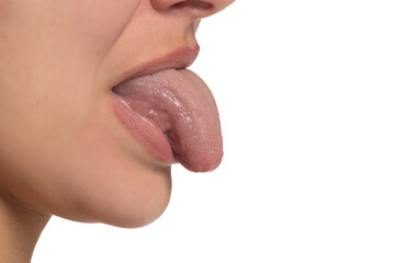 Female sticking out tongue, close up, side view.