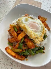 Stir fried crispy pork and red curry paste. Thai food.