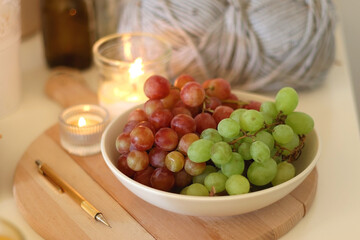Pumpkins, various food and drinks, fall decorations, books and candles on the table. Fall hygge at home. Selective focus.
