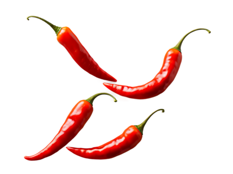 Falling_sliced_red_hot_chili_peppers_isolated_on_white_background,_selective_focus