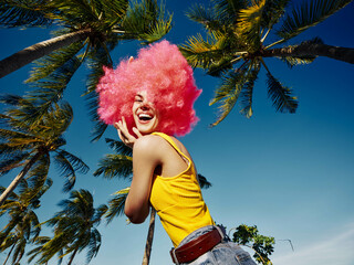 Pinkhaired woman, palms a vibrant woman with pink hair and a matching wig poses with her hands on...