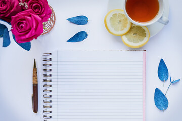 Above, tea and relax with notebook in studio for diary, vision board and agenda planning. Flowers,...
