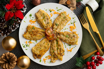 Battered anchovies, traditional Spanish tapa from the Malaga area. Table with christmas decoration.