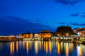 Nafpaktos port blue hour. A beautiful touristic destination with the town lights reflecting water.
