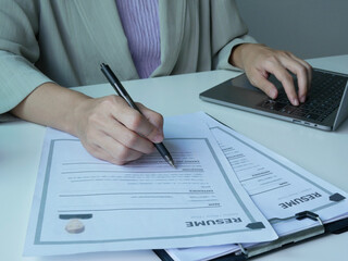 Businesswoman employer is evaluating resume to hire applicants. Holding resume to hire applicants. Analyzing data before job interview. Recruitment concept