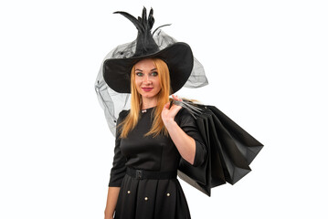 Happy Halloween witch with shopping bags, dressed in black and spooky makeup, celebrates the holiday season with magic and style on a white background