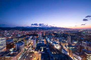 Fototapeta premium sunset or sun rise of Sapporo cityscape with Skyline and office building and downtown of sappiro is populars ciy from toursim Hokkaido, Japan with twilight sky in spring season