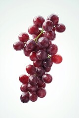 Fototapeta premium Bunch of red grapes hanging on white background