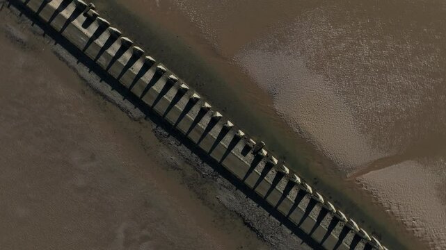 Aerial view of Cramond Island with serene beach and tranquil shoreline, Edinburgh, United Kingdom.
