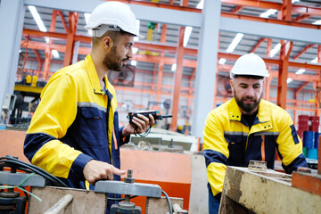 Male engineer working at metal sheet factory, industrial concept.