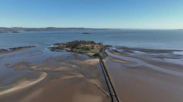 Aerial view of Cramond Island with serene coastline and tranquil waters, Edinburgh, United Kingdom.