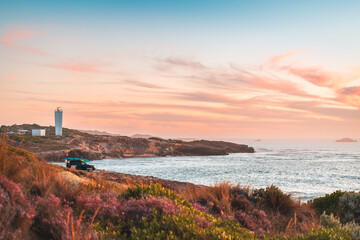 4WD car parked on rocky beach in Robe with driver enjoying the scenic sunset view with ocean, South Australia © myphotobank.com.au
