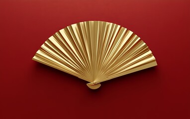 A single, golden fan floating against a rich red background in minimalist style