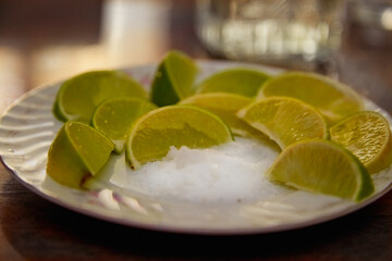 lime slices for tequila on a plate with salt