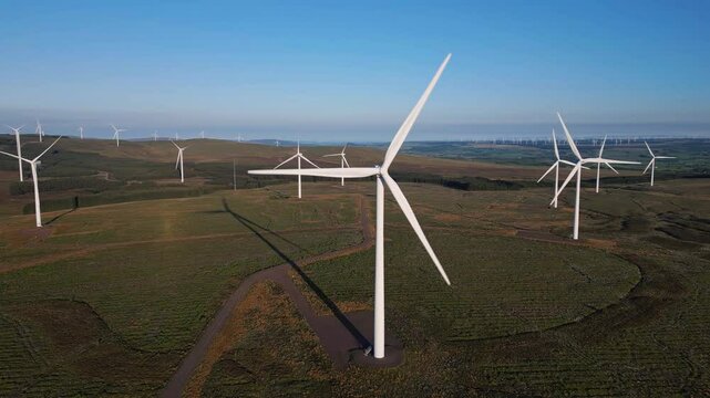 Aerial view of a beautiful wind farm with numerous wind turbines in a scenic landscape, East Kilbride, United Kingdom.
