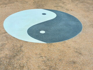 Yin-Yang symbol on a brown background. White and black in a circle. Balance of two opposite colors in a circle. white dots in black - Black in white. 1white dot in black area. 1black dot in white area