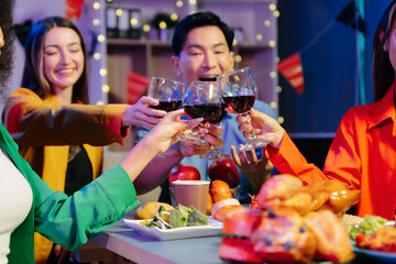 A diverse group of coworkers enjoying a casual office party or home with drinks, food,