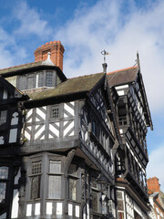 Typical large old half timbered tudor building in Chester city centre with overhanging bays and brick chimneys