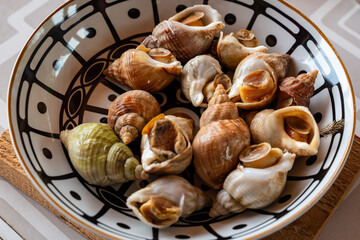edible sea snails in a bowl served in France as a gourmet appetizer