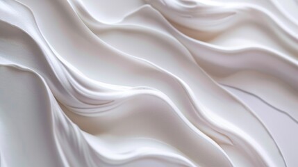 Obraz premium Cream moisturizer close-up with wavy texture on white background - skincare product.