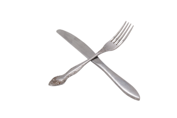 Metal fork and table knife lying crosswise without background. Restaurant etiquette. Horizontal.