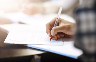 Naklejka premium Writing, education or hand of person in college for learning, notes or accounting course. Student, books or studying at table for exam preparation, finance assignment or lesson on stats in university