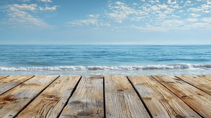 Wooden pier extending into a calm ocean with clear skies in the background