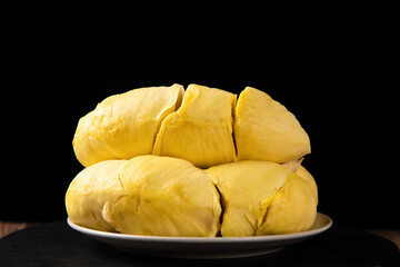 Fresh peeled ripe durian on wooden table.