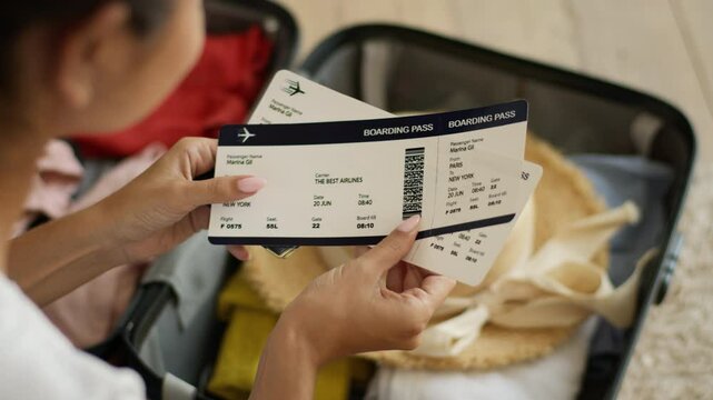 Arabian woman at home Indian girl female traveler tourist hold passport travel agency tickets packing suitcase baggage luggage check time airplane preparing trip vacation holiday anticipation airline