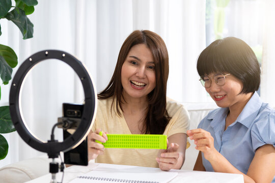 Teaching Braille to visually impaired individuals, the instructor patiently guides them through each tactile symbol, empowering them with a new way to read and communicate. - Powered by Adobe