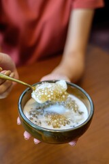 Close-up of coconut ice cream with passion fruit topping served in a glass bowl