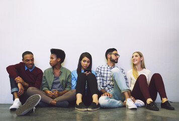 People, students and line for interview, job search or training program on a wall background in lobby. Diversity, audition and waiting room for career internship, mockup space or business opportunity