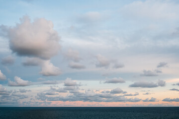 Panorama nature view soft oceans waves with a deep blue color on the sea with overcast cloudy and sunset background