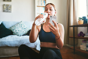 Woman, smartphone and yoga break with drinking water at home for social media interaction. Female...