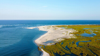 Aerial view of the inlet with sand and grassy marsh