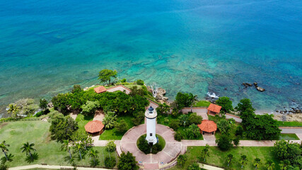 Aerial view of the Rincon Lighthouse along the turquoise water in Puerto Rico