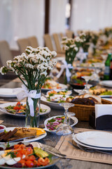 Elegant Dining Experience with a Lavish Banquet Spread and Delicate Floral Touches