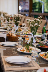Elegant Outdoor Dining Table Set for a Luxurious Event with Decorative Floral Centerpieces