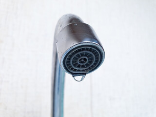 A dripping faucet. A broken water faucet. A drop of water from the faucet, lack of water supply,...