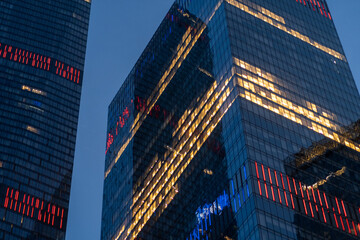 Modern Moscow City towers against a blue sky. Tall glass skyscrapers with reflec