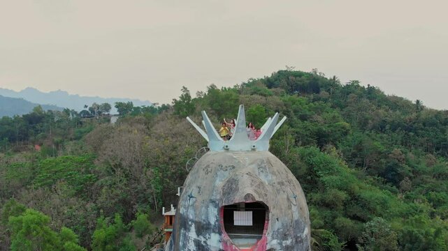 Aerial view of gereja ayam (chicken church) surrounded by lush forest and hills, Yogyakarta, Indonesia.