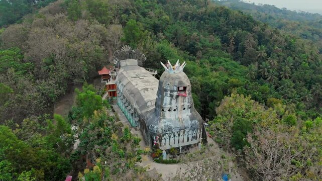Aerial view of the unique gereja ayam (chicken church) surrounded by lush greenery and forest, Yogyakarta, Indonesia.