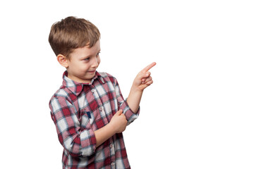 A boy with a bright smile points his finger against a white background, expressing curiosity and enthusiasm in his clear gaze