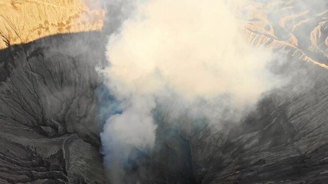 Aerial view of the majestic Bromo volcano with a smoking crater at sunrise, Bromo, East Java, Indonesia.