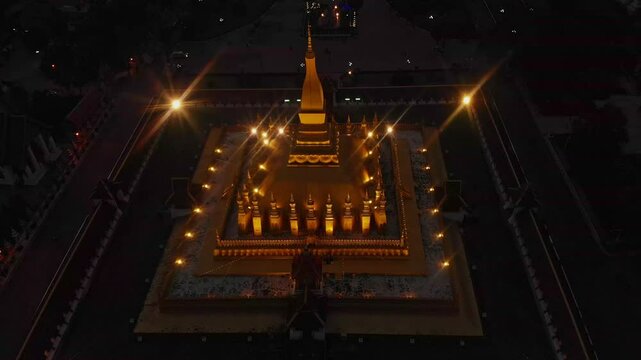 Aerial view of illuminated pha that luang stupa at night, Vientiane, Laos.